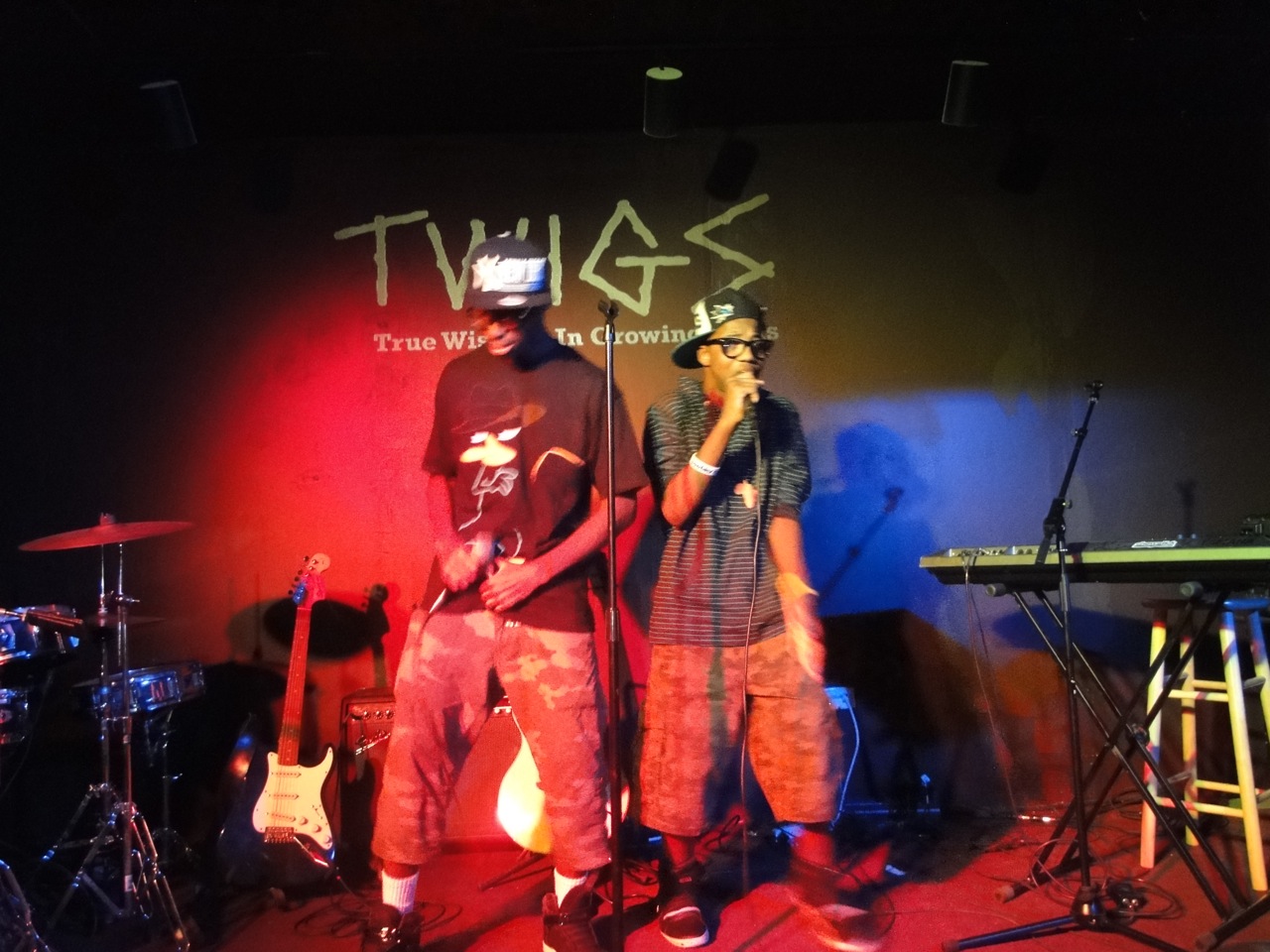 Two young performers sharing the stage beneath the T.W.I.G.S. logo.
