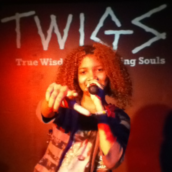 A young performer sharing their voice at a T.W.I.G.S. Youth Open Mic.
